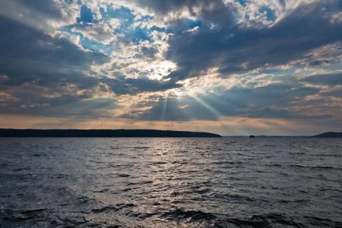 Sun shining thru clouds Stock Photos