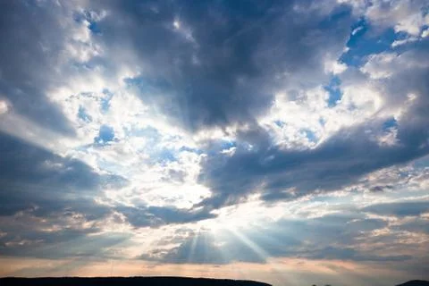 Sun shining thru clouds Stock Photos