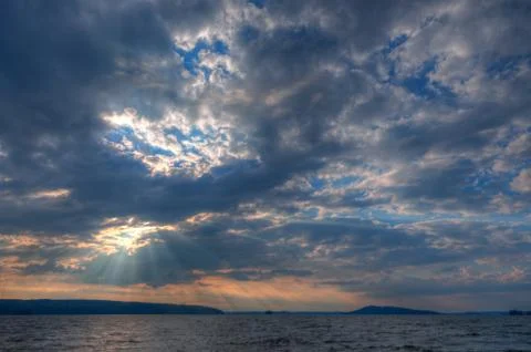 Sun shining thru clouds Stock Photos