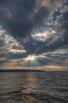 Sun shining thru clouds Stock Photos