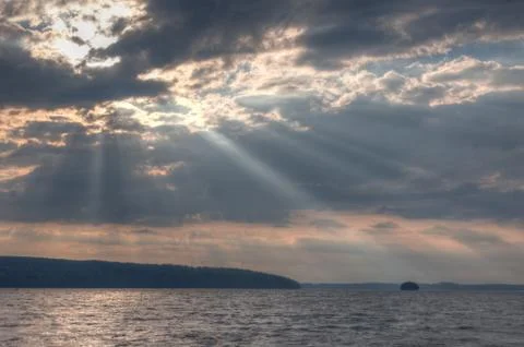 Sun shining thru clouds Stock Photos