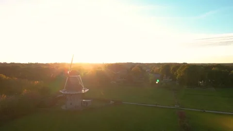 Sun shining on traditional dutch windmill during golden hour Video stock 293158010
