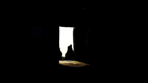 Sun shining trough the doors of the Parambanan hindu temple Java Indonesia Video stock 126800826