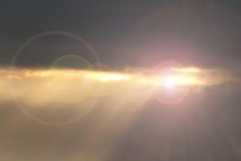 Sun shinning from behind  clouds after the storm, lens flare effect Stock Photos