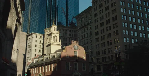 Sun shinning on colonial Old State house in Boston around skyscrapers Stock Footage 219025994