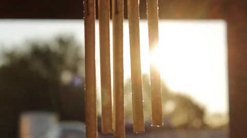 Sun Shinning Through Old Wind Chime Video stock 78570087