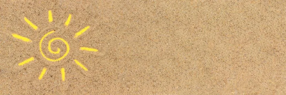 Sun sign drawn on sand. Creative top view Copy space Banner Stock Photos
