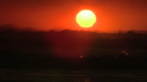 Sun silhouetting waves Stock Footage 11143535