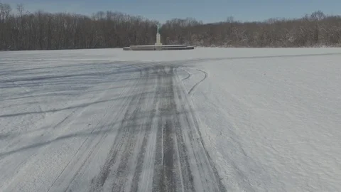Sun Singer statue in Snow at Allerton Park [Dolly In] Stock Footage 128481938