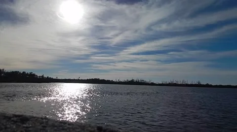 Sun sinking in the sky over shimmering waters Vídeos de archivo 45198070