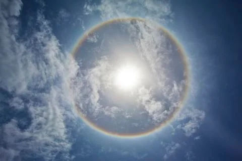 Sun with sircular rainbow and clouds Stock Photos