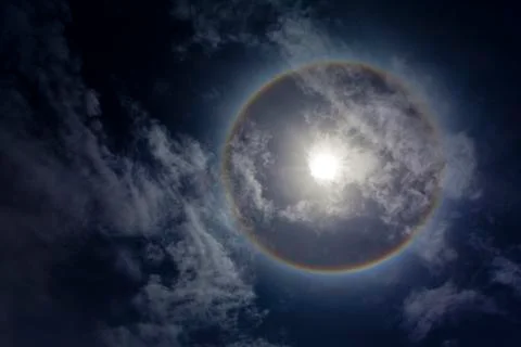 Sun with sircular rainbow and clouds Stock Photos
