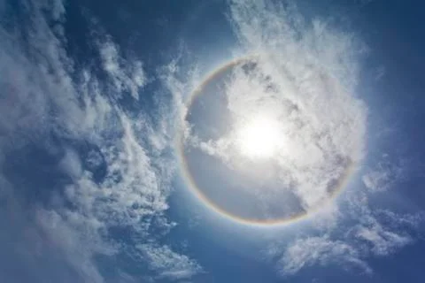 Sun with sircular rainbow and clouds Stock Photos