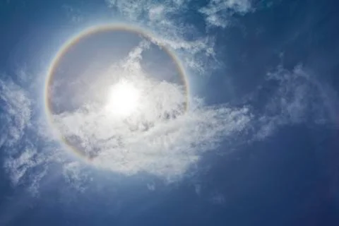 Sun with sircular rainbow and clouds Stock Photos