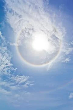 Sun with sircular rainbow and clouds Stock Photos
