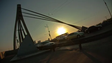 The sun sits behind the bridge, traffic. The night begins. Full HD Timelapse	 Stock Footage 74264782