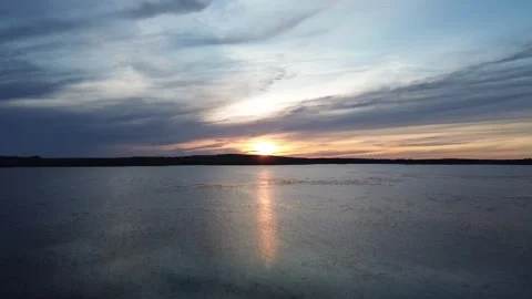 The Sun Sits on the Horizon, with its Reflection on the Water. Stock Footage 312237838