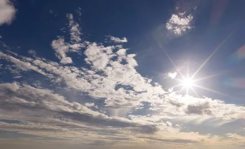 Sun on sky background. Sun in clouds. Sun rays in cloudscape. Sun bright summ Stock Photos