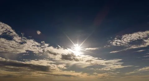 Sun in sky background. Sun rays on cumulus clouds. Sun bright daylight. Sun.. Stock Photos