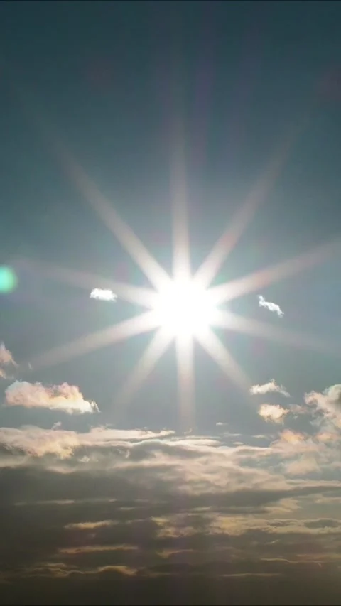The sun is in the sky, bright rays illuminating the sky and clouds - Vertical vi Stock Footage 300585329