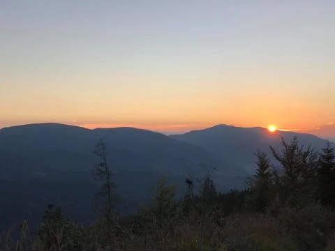 The sun sleeps in the mountains Stock Photos