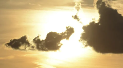 Sun slowly melts away clouds time lapse HD 1080 version zoomed Stock Footage