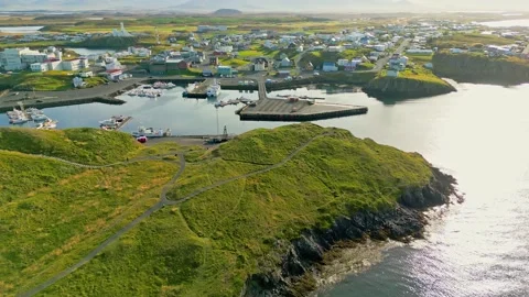 Sun slowly setting over Stykkisholmskirkja Harbour Stykkisholmur town Stock Footage 233035117