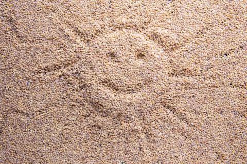 Sun smiley emoticon shape mark on Barley grain malt background Stock Photos