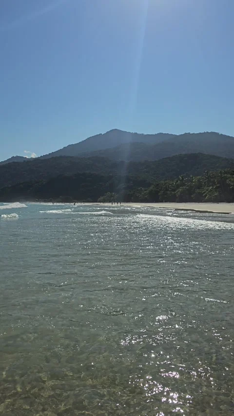 Sun-Sparkled Shallow Surf Below Mountain, Ilha Grande, Brazil – Vertical 8K Video stock 306485918