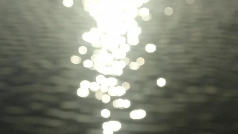 Sun sparkles on grey waves soft focus to sharp to soft again Stock Footage 73340237