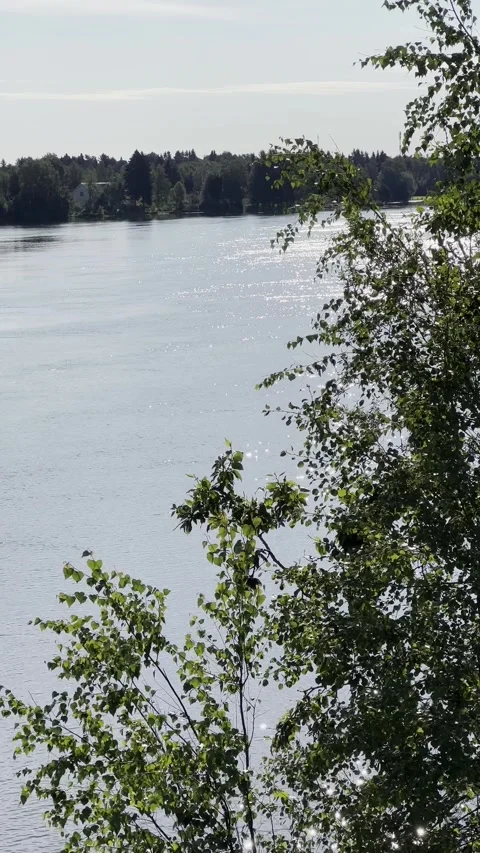 Sun sparkling on Oulujoki river, vertical, Oulu Finland Stock Footage 247172771