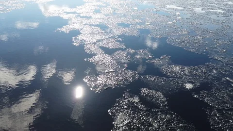 Sun sparkling on water surface with melting ice Stock Footage 128303050