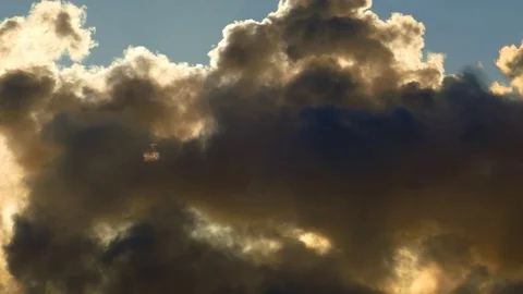 Sun squeezes between thick winter clouds with silver lining Stock Footage 71441040