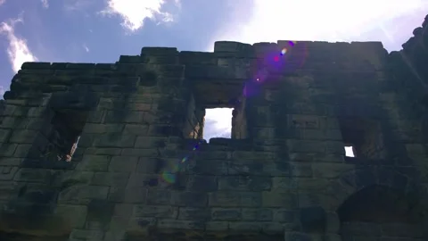 Sun stars through window of Medieval abbey ruins in England Video stock 344747528