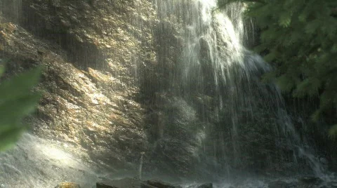 Sun streaked waterfall up close Video stock 531305
