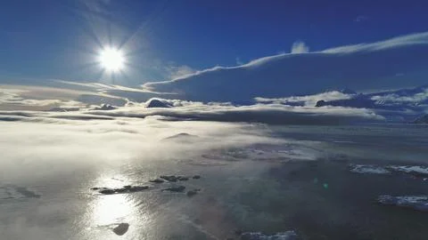 Sun, sun path over ocean fog. Aerial drone flight. Stock Photos