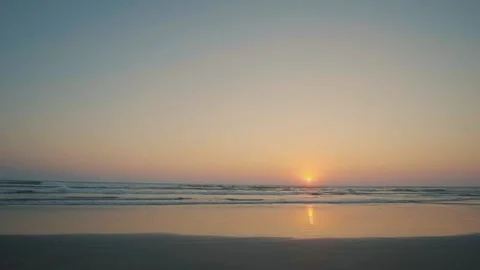 The sun at sunset on a beach without people Video stock 130408446