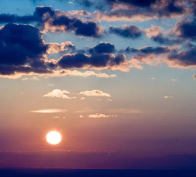 Sun at sunset cloudscape Stock Photos