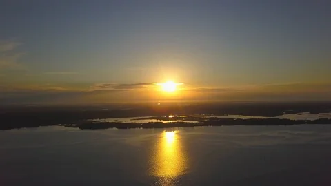 The sun at sunset is reflected in the river. Aerial. Video stock 112764330
