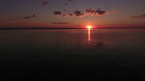 Sun sunset right above the horizon line. above a river Stock Footage 78627743