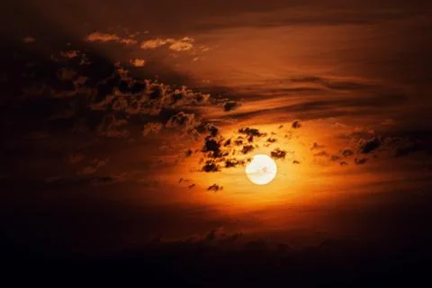 The sun surrounded by clouds at sunset view Stock-Fotos