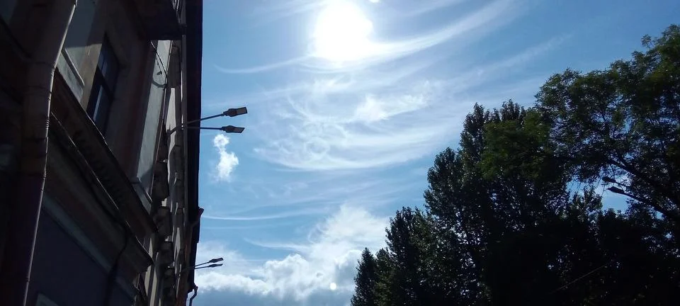 The sun surrounded by feather clouds Stock Photos