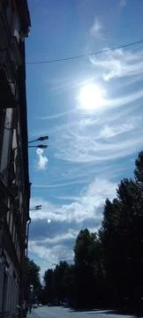The sun surrounded by feather clouds Stock Photos
