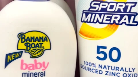 Sun tan lotion display in a retail grocery storer pan Coppertone and Banana B Stock Footage 174383399