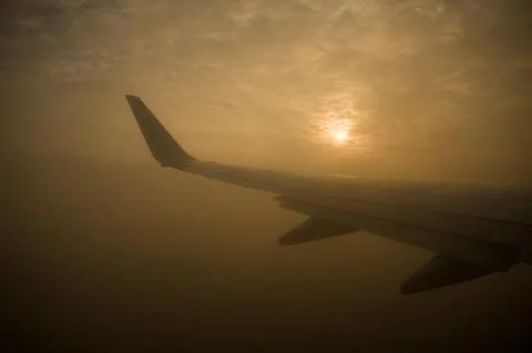 The sun is through the clouds. View from the airplane window. Stock Photos