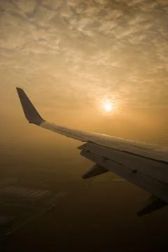 The sun is through the clouds. View from the airplane window. Stock Photos
