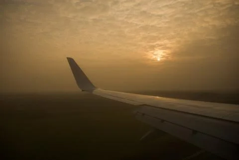 The sun is through the clouds. View from the airplane window. Stock Photos