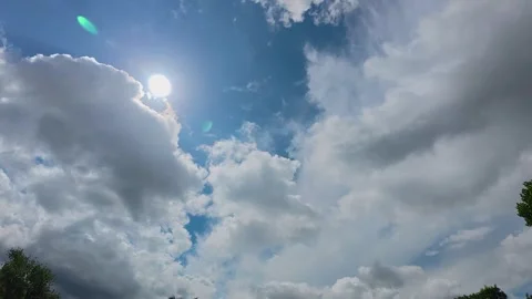 Sun Through Cumulus Clouds in Sky timelapse Stock Footage 313148775