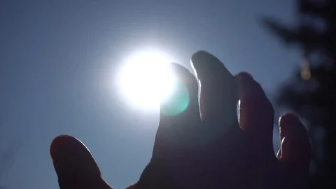 Sun through man's fingers Stock Footage 82906949