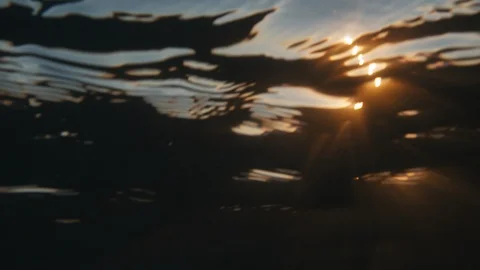 Sun through ocean surface then reveal sunset above it Stock Footage 117641816